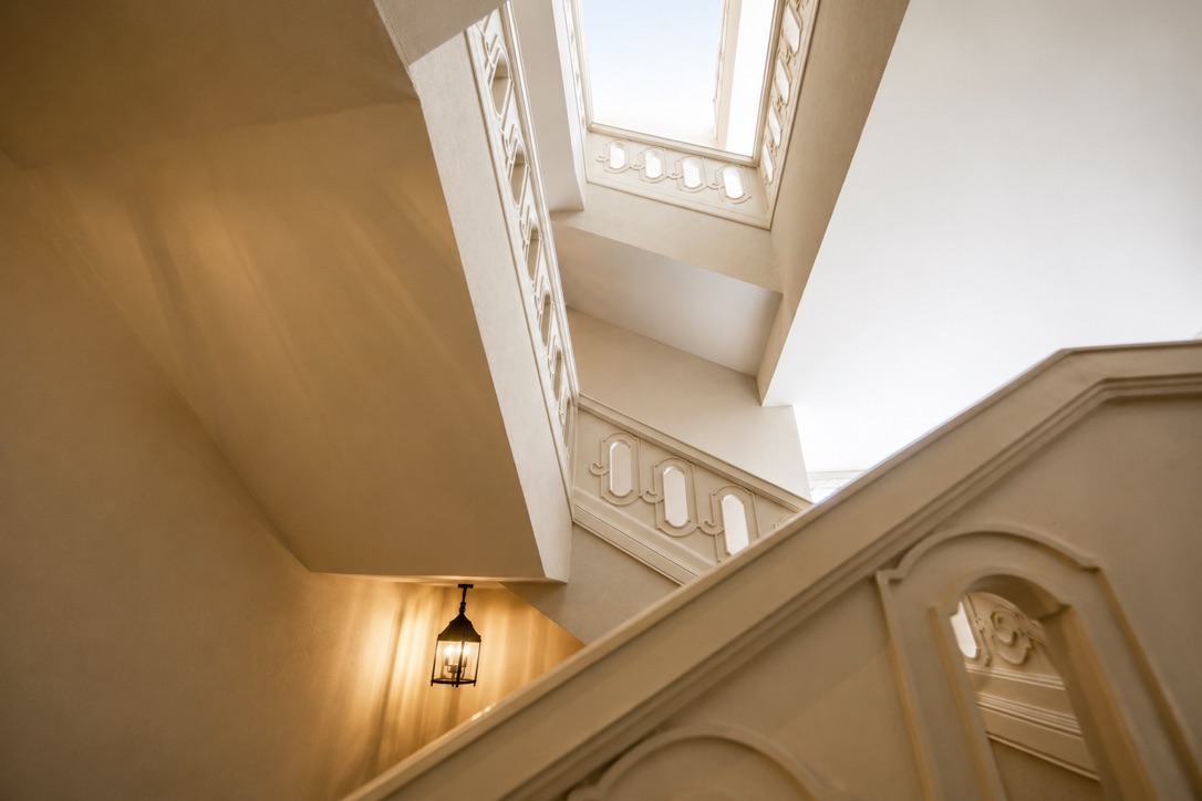 Upward view of a stacked stairwell and skylight