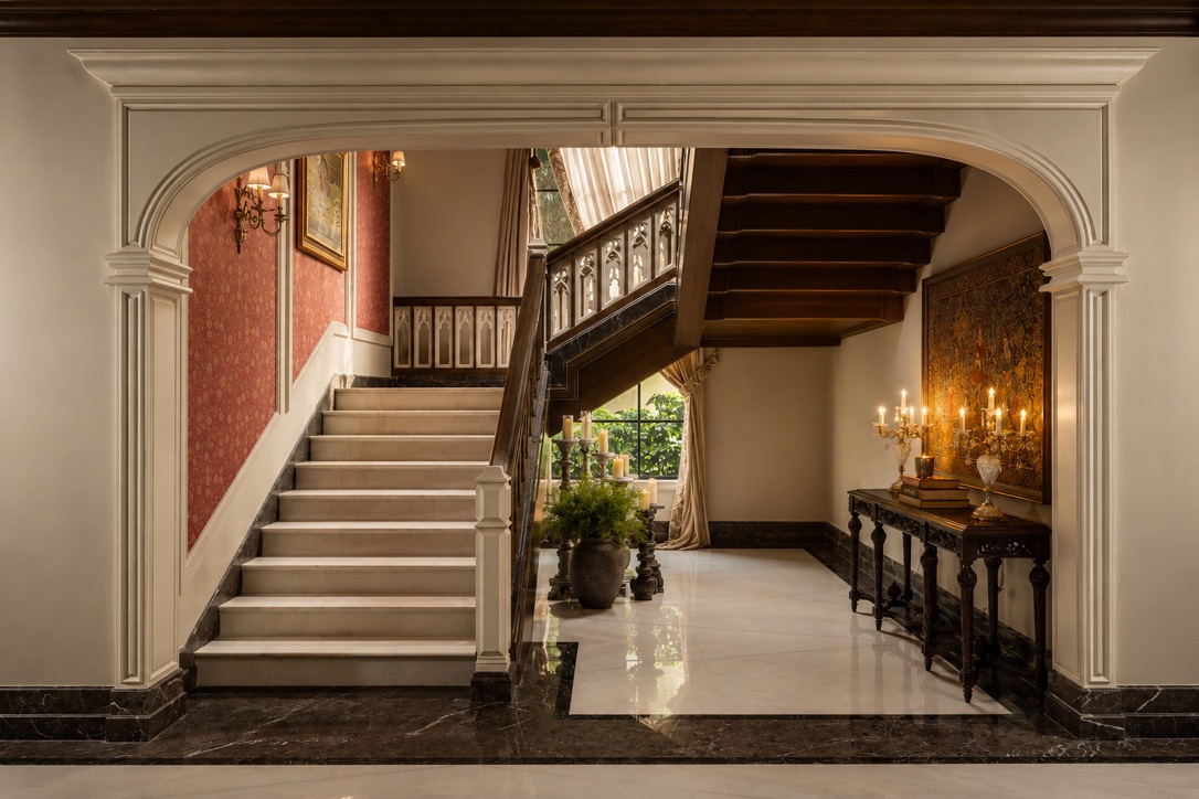 Marble stair hall framed by a moulded archway