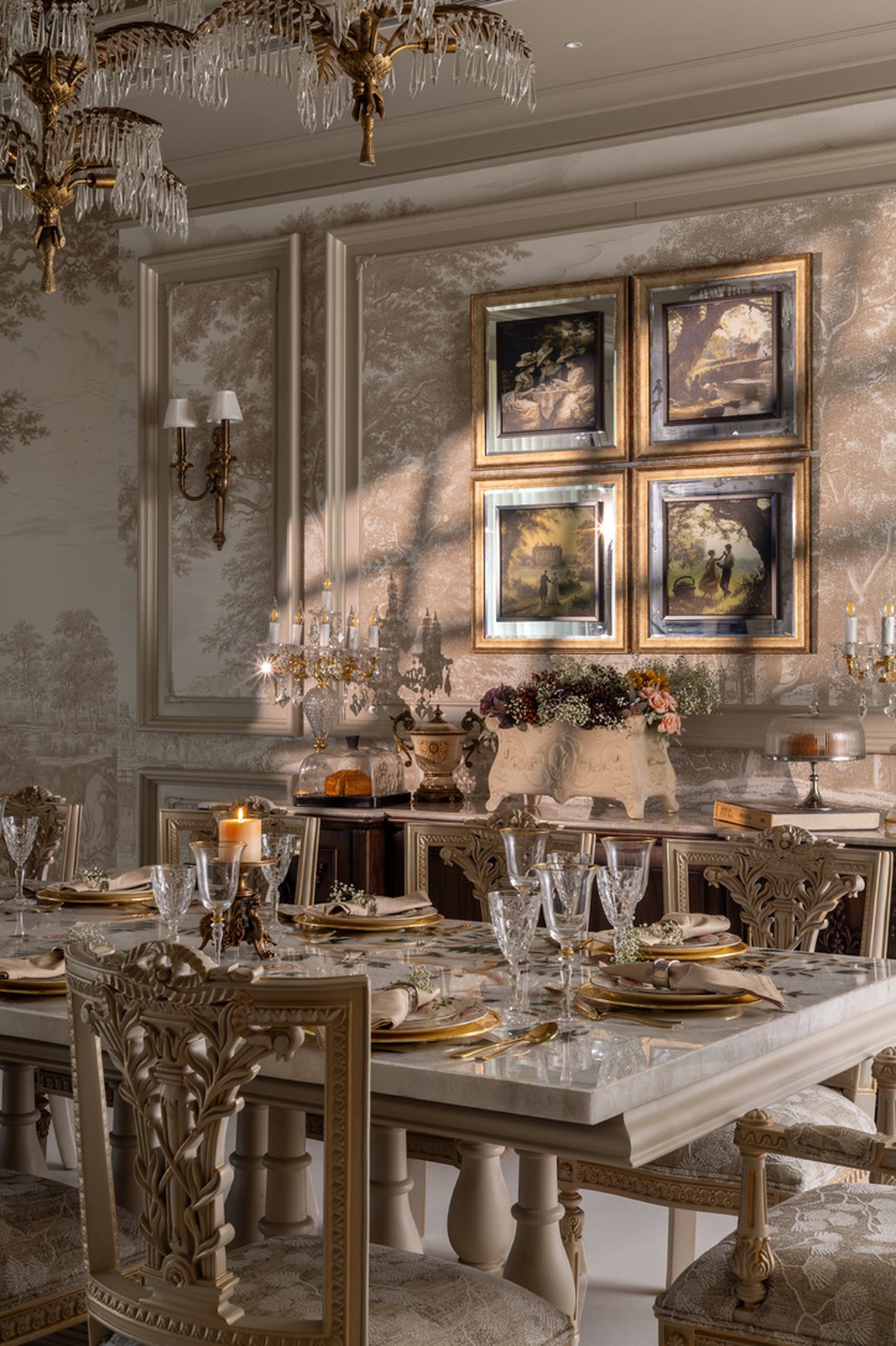Ornate ivory and gold bedroom with carved armchairs